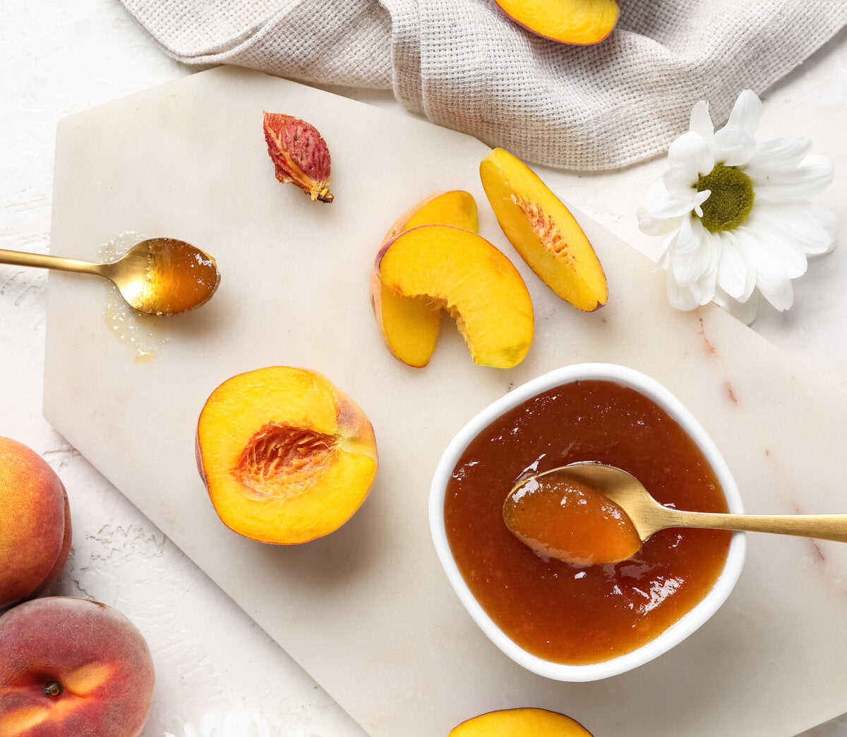 A bowl of healthy peach jam made using a traditional recipe from fresh fruit.