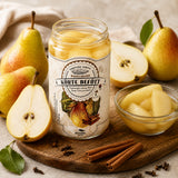 Jar of pear compote slices with fresh pears, cinnamon sticks, and cloves on a neutral fabric background.
