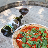 A glass of Hungarian Bull's Blood red wine is the best pairing for a meaty pizza with tomato sauce.