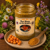 Jar of raw honey with ground sea buckthorn powder from buckhorn berries, with flowers in the background