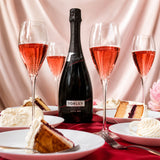 Bottle and glasses of Torley rose sparkling wine with slices of cake.