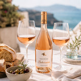 Bottle of Szentpetery rose wine with two glasses, tapas and bread on a scenic background