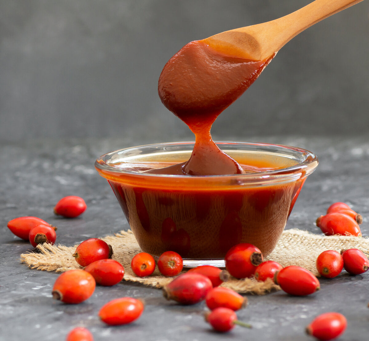A bowl of rosehip jam made from fresh rosehip berries.