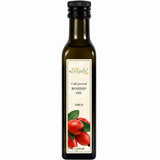 Bottle of cold-pressed rosehip oil on a white background.