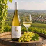Bottle of Lajver Sauvignon Blanc wine with a glass of white wine and Sauvignon Blanc grapes on a barrel.