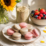Plate of pink and light-brown macarons made with sunflower seed flour.