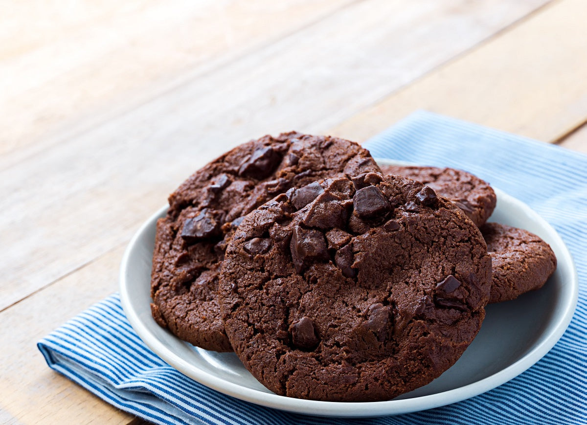 Dairy-free and vegan double chocolate chip cookies on a white plate.