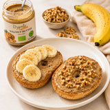 Creamy walnut butter spread over bagels, topped with fresh walnuts and banana slices.