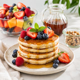 American-style pancakes made with walnut flour and topped with fresh berries and maple syrup.