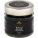 A jar of whole black truffle, made by preserving black summer truffle pieces.
