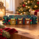 Christmas honey gift set displayed on a festive table beside a tree and wrapped present.
