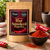 Hungarian Hot Smoked Paprika pouch beside vivid paprika powder and red peppers.