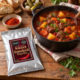 Hungarian Sweet Smoked Paprika 500g pouch lying flat beside a pot of beef goulash.