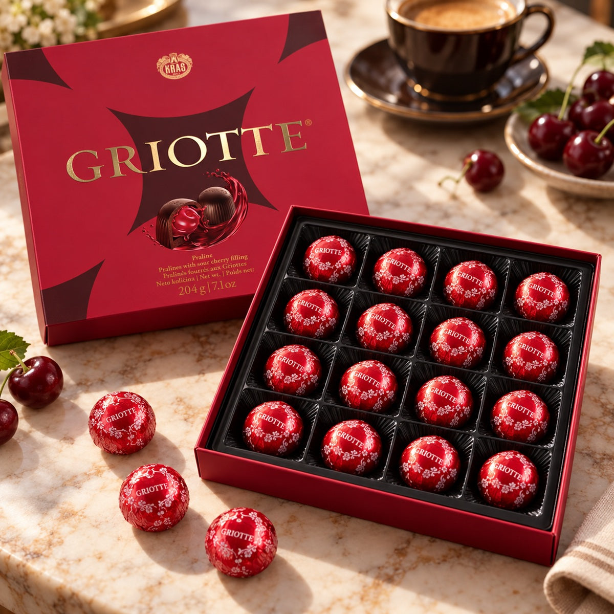 Open Kraš Griotte box with 16 individually wrapped sour cherry chocolates and coffee.