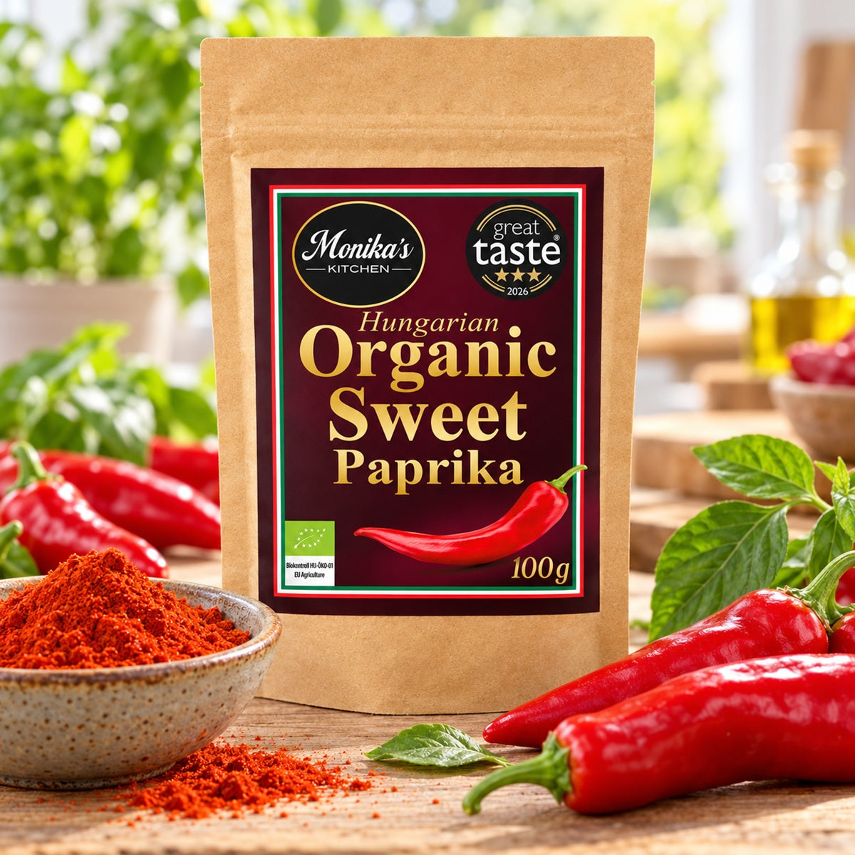 Monika's Kitchen Organic Sweet Paprika pouch beside red peppers and a bowl of vivid paprika powder.
