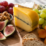 Cheese board with ash cheese and fruits.