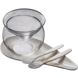 A luxury caviar serving set with a glass server dish, ceramic plate and the best mother-of-pearl spoons.