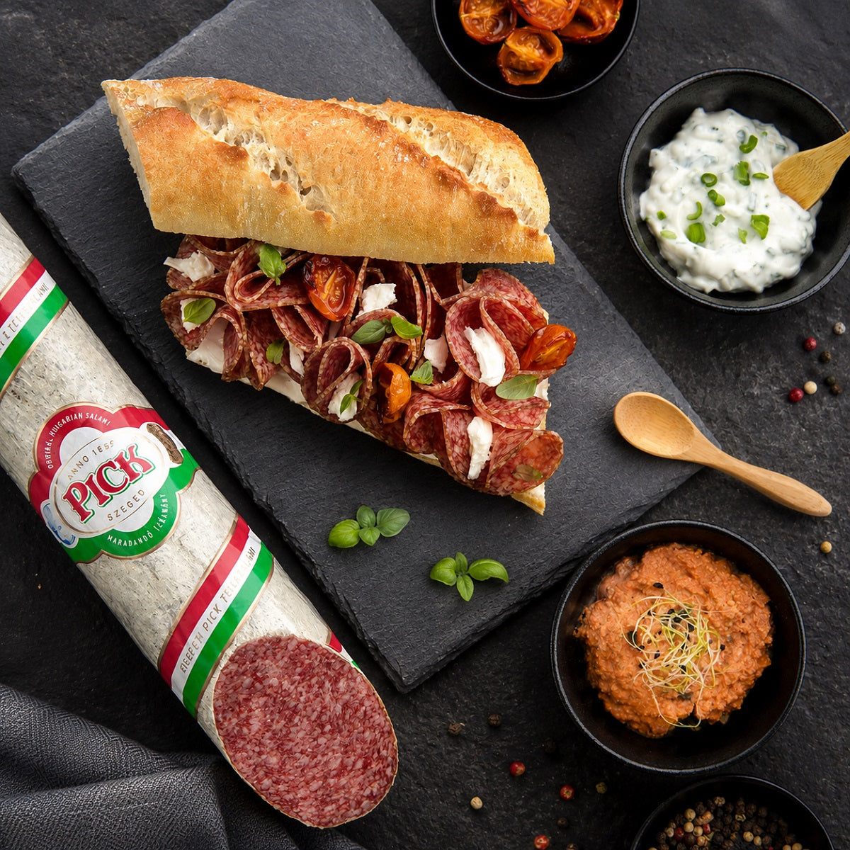 Pick salami slices in a baguette with dips.