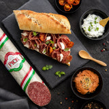 Pick salami slices in a baguette with dips.