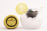 A tin of Malossol Siberian sturgeon black caviar from the best fish egg roe served on ice with a pearl spoon.