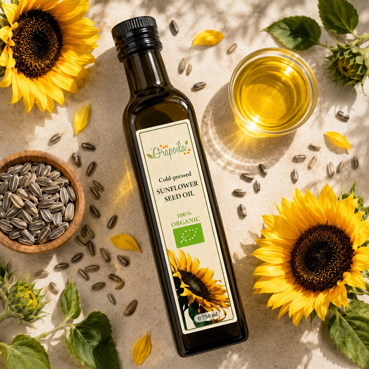 Bottle of cold-pressed organic sunflower seed oil with sunflower seeds and sunflower flours.