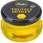 A jar of truffle honey made by infusing acacia honey with black summer truffle slices, it is best with cheese.