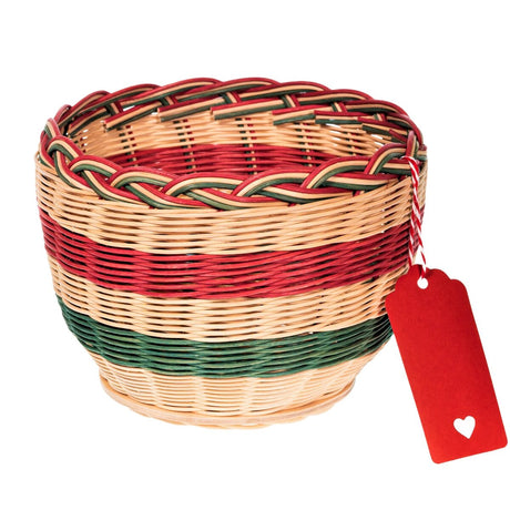 An empty wicker hamper basket in a red, white and green for Christmas gifts.